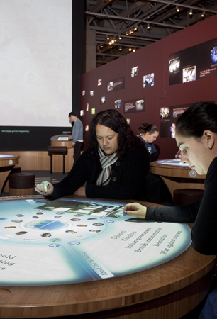 Photograph exploring the stories and artwork on a touch-screen table