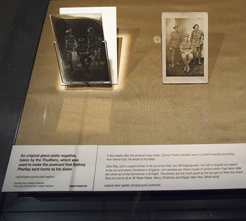 Showcase containing an original glass plate negative and the postcard created from it