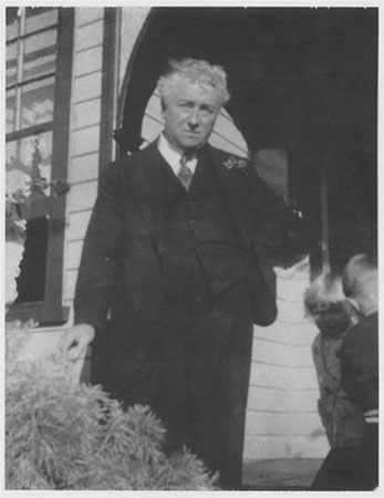 Joseph Lyons standing in front of Home Hill, 1936