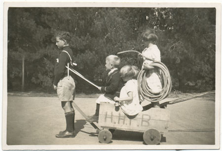 The Lyons children playing with the fire engine they made themselves for the Home Hill Fire Brigade, 1930s