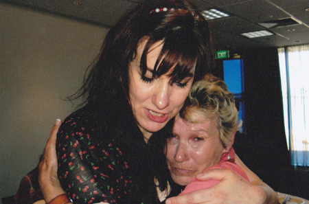 The author comforts Wendy, a Forgotten Australian, at a lunch for guests who contributed to the Inside exhibition