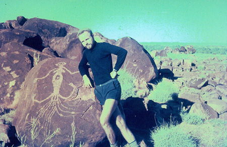 German emigrant Karl-Heinz Dietzel in the western Pilbara region of Western Australia, next to an Aboriginal carving of a spiritual being