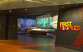 An entrance to an exhibition with a sign 'First Peoples'