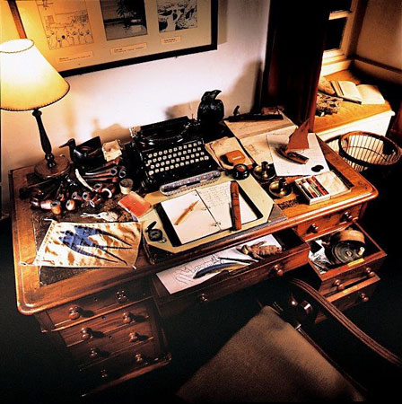 The display based on the table that Arthur Ransome inherited from his mother, including his typewriter, the Russian candle-sticks, writing impedimenta and a selection of his many pipes