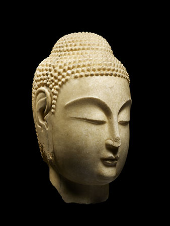 A white marble head depicting Buddha