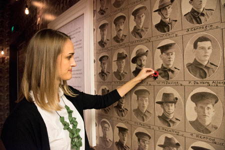 Photographs and names of Queensland soldiers who fought in the First World War blanket the walls of the entrance space