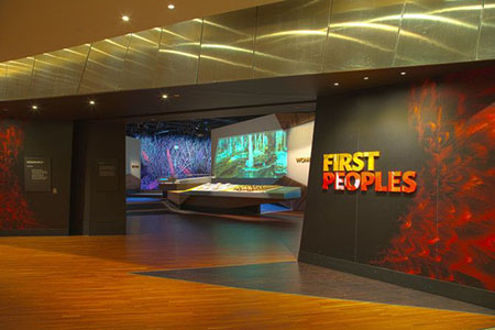 An entrance to an exhibition with a sign 'First Peoples'