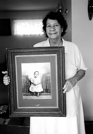 Eileen Rallah with a photo of herself as a child, Mount Gravatt, 2001