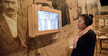 A visitor listens to personal stories of the First World War in the <em>Distant Lines</em> exhibition