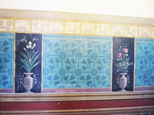 A section of the dado, which runs the length of the upstairs hallway at Villa Alba, decorated with diapered ‘medieval’ patterns and hand painted panels depicting jonquils and roses in Aesthetic, stylised urns