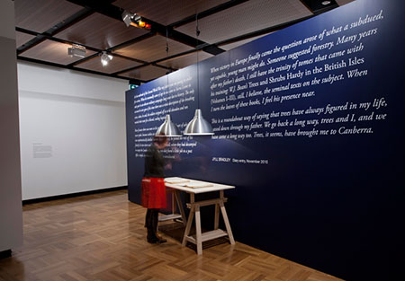 The memory book sits in front of wall text work by Jyll Bradley, 2013