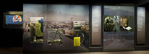 Display case in the gallery with one showing a bicycle that has an IED concealed on it