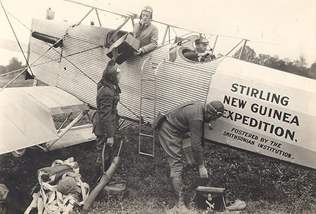 Four American expedition members with the airplane as they set out from Maywood, Illinois, 1925