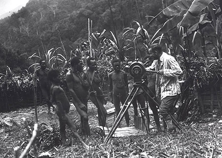 Richard Peck using a movie camera to film villagers