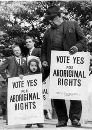 Image of Bill Onus and child holding Aboriginal rights posters