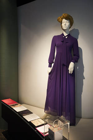 The ‘Florence’ dress designed by Hijab House, with a multimedia label strip in the foreground that includes a mix of labels written by the Muslim women featured in the exhibition, children’s labels, creative process material and touch samples