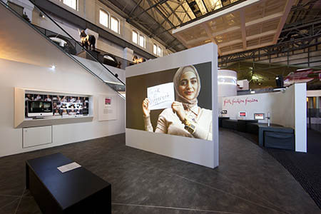 An interactive photo booth where visitors are invited to write something about themselves on a placard and save a photo of themselves to the photo stream – a process that challenges them to examine their own assumptions when judging people based simply on appearance